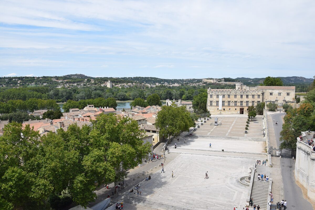 The pale front of the Petit Palais across a wide stone square, with trees and rooftops on one side