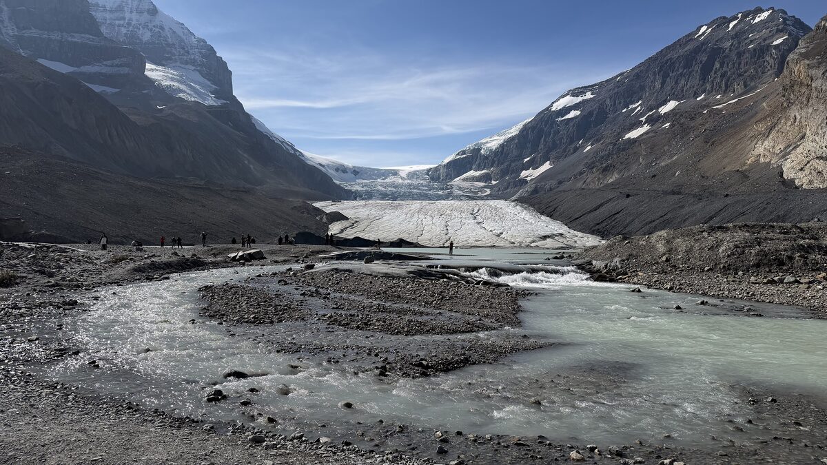 The Athabasca Glacier's toe and meltwater stream between two mountain flanks