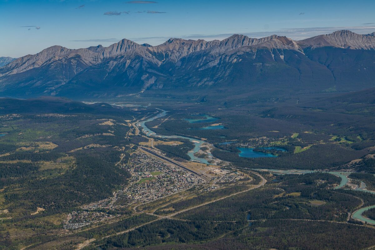 Aerial view of Jasper townsite beside the Athabasca River and the Rockies