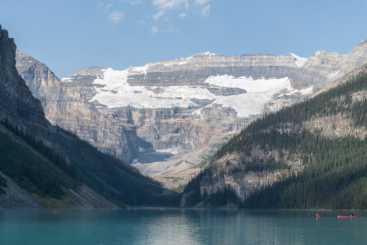 Lake Louise with its canoes below Mount Victoria and the Victoria Glacier