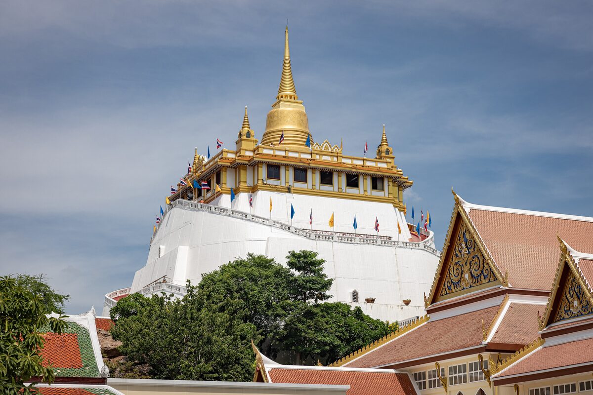The Golden Mount, a white hill crowned by a gilded chedi, rising above the temple roofs of Wat Saket