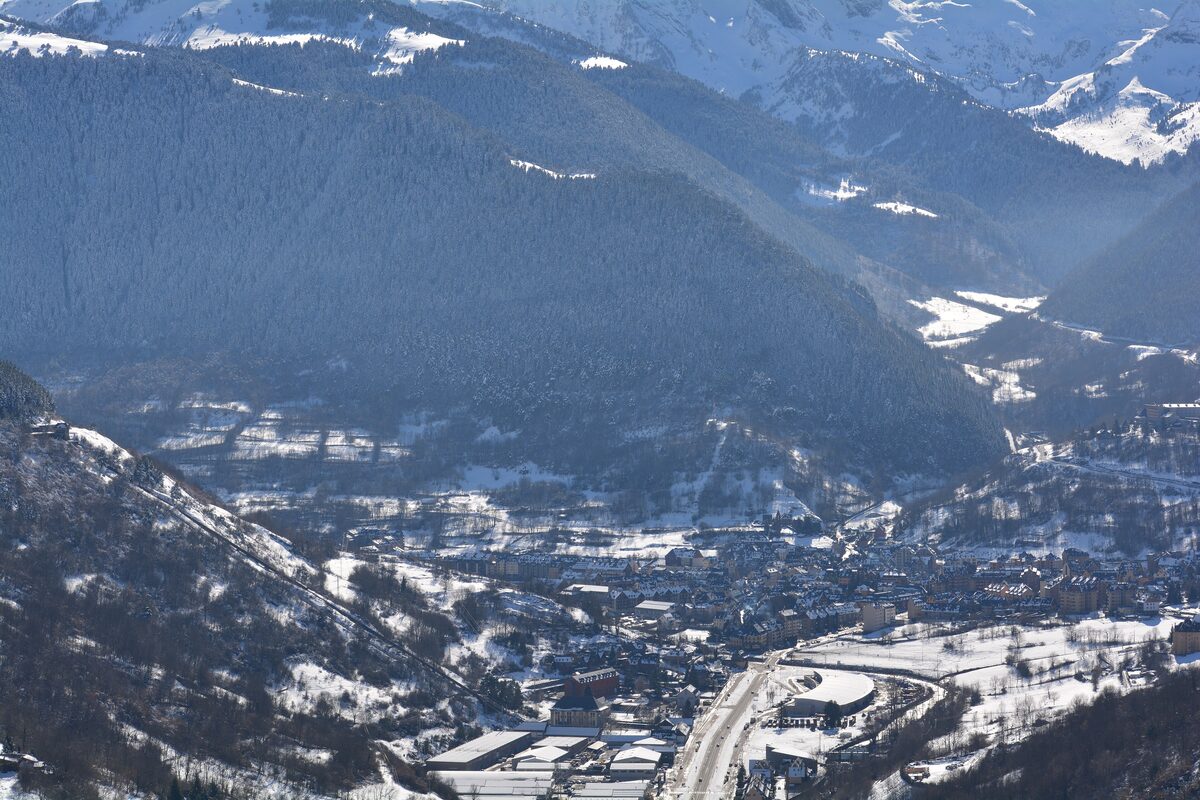 Vielha in the valley below snowy mountains, seen from above