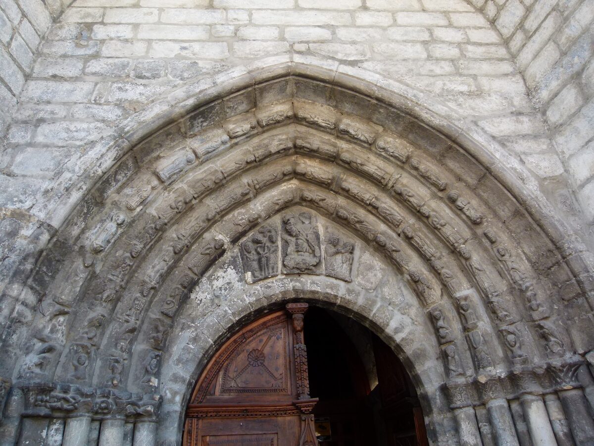 The carved stone portal of Sant Miquèu in Vielha, with its arches and tympanum