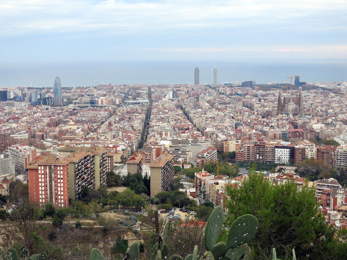 The Eixample grid, Torre Glòries and the Sagrada Família stretching to the sea, seen from the hill of Turó de la Rovira