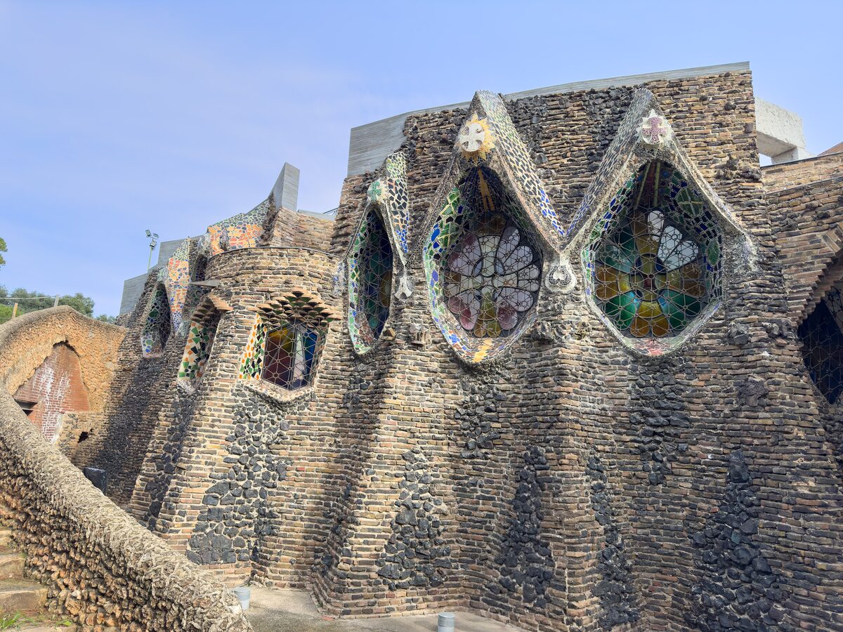 Stone walls and stained-glass windows of the Colònia Güell crypt