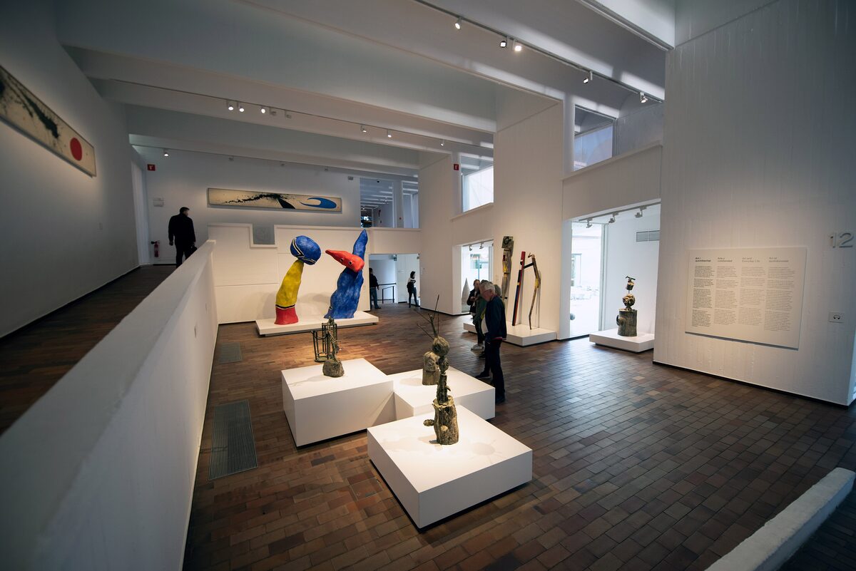A gallery room inside the Miró Foundation with sculptures on white plinths