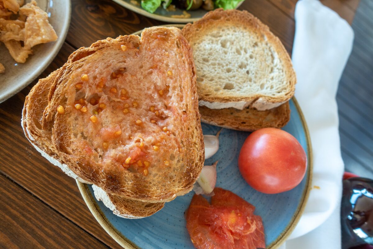 Toasted bread rubbed with fresh tomato and garlic on a plate