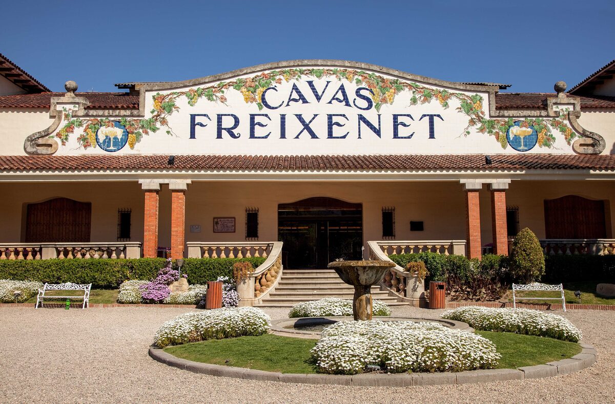 The tiled Cavas Freixenet entrance in Sant Sadurní d'Anoia, with a flower bed in front of the cava house