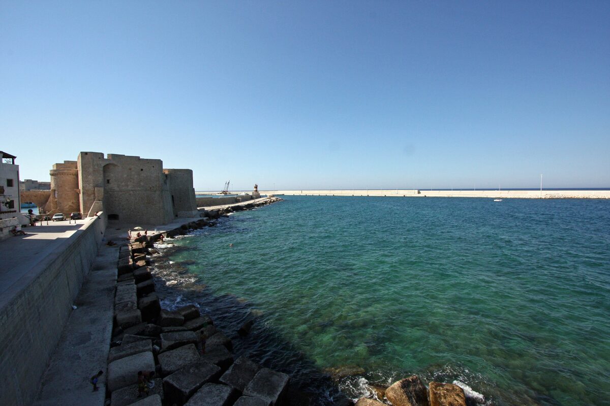 The Castle of Charles V at the mouth of the Monopoli harbour, with the breakwater running out to the sea