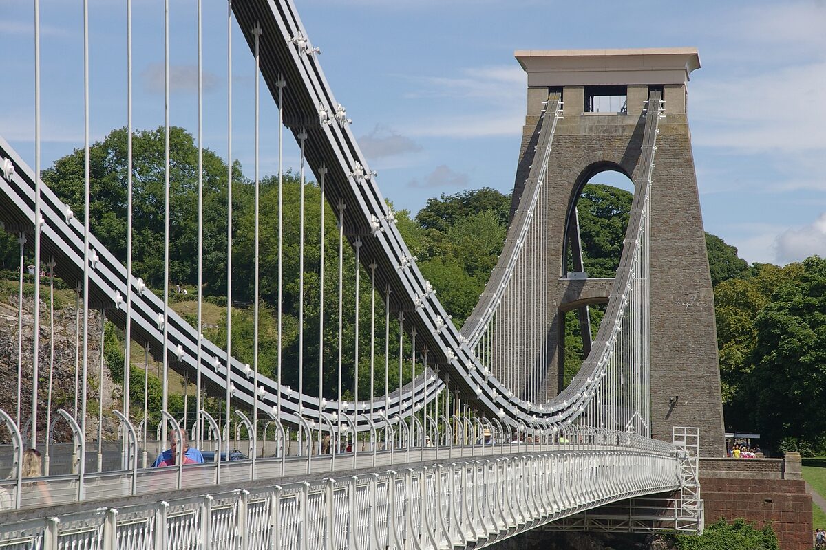 The Clifton Suspension Bridge in Bristol, with its stone tower, chains and the wooded Avon Gorge behind