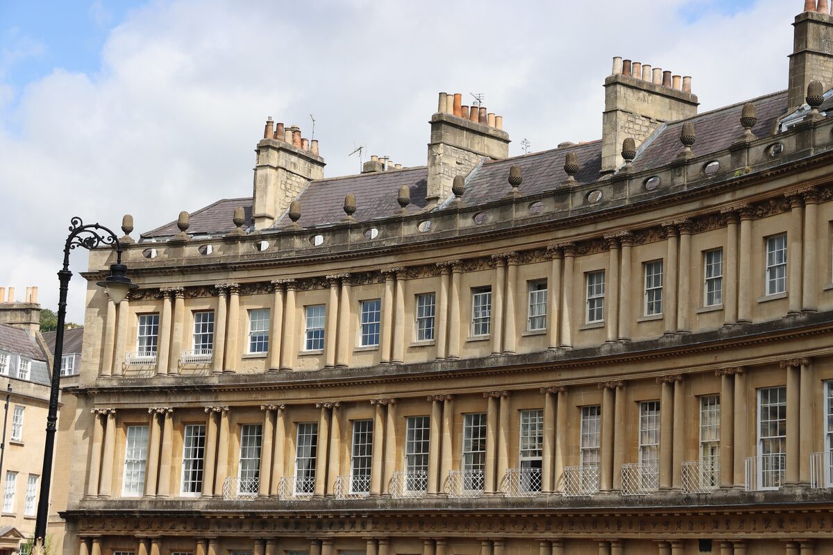 The curved Georgian terrace of the Circus in Bath, with three stacked rows of columns and acorns on the parapet