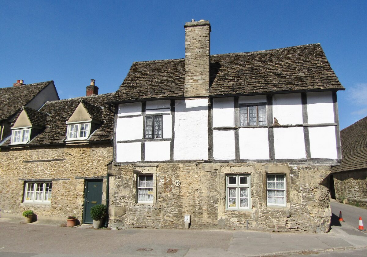 A quiet street of old stone and half-timbered cottages in the village of Lacock