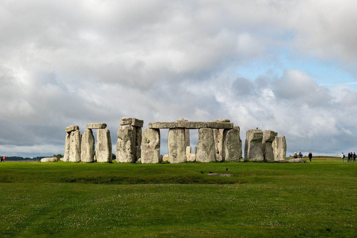 The standing stones and lintels of Stonehenge on Salisbury Plain under a pale sky