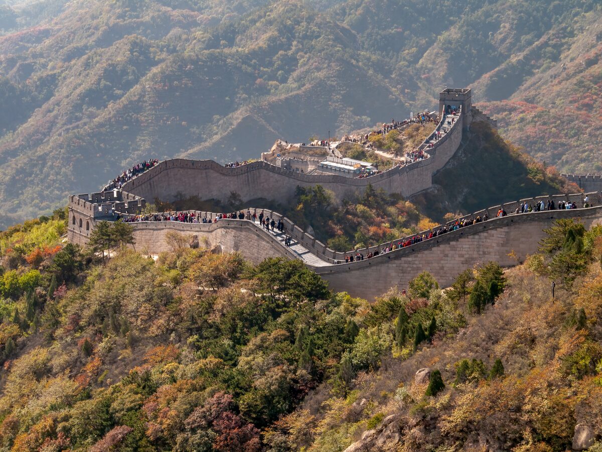 The Great Wall at Badaling winding over a steep ridge in autumn colors, with visitors along the wall