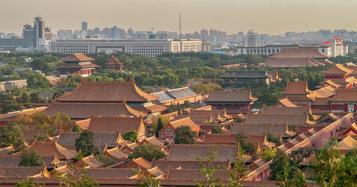 The golden roofs of the Forbidden City seen from Jingshan Park with the city beyond