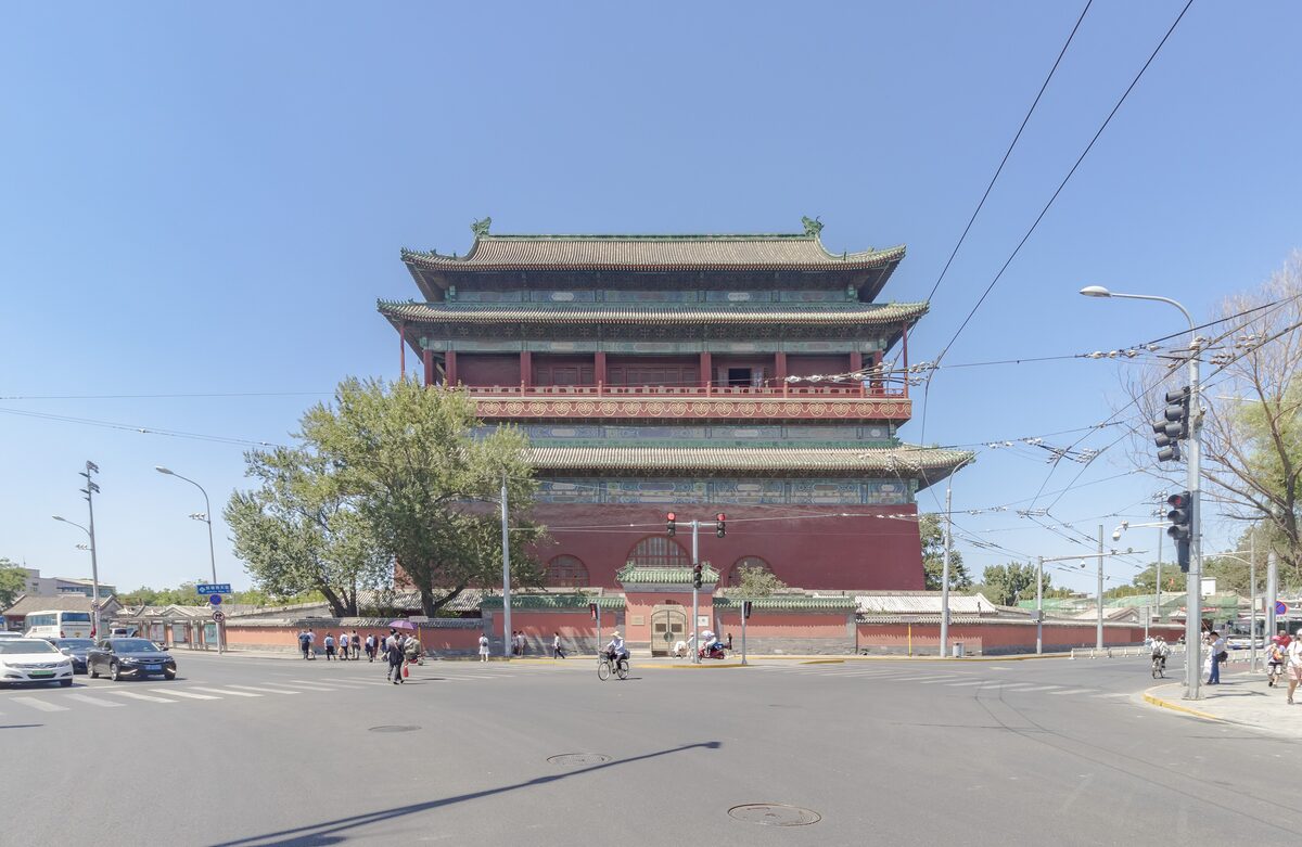 The Drum Tower, a tall red-walled hall with a green-tiled double roof, seen from the street in front