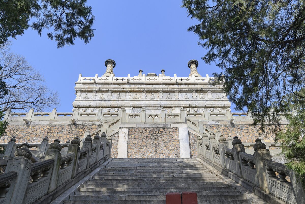 The white marble Vajra Throne pagoda of Biyun Temple in Fragrant Hills Park, seen up a flight of stone steps