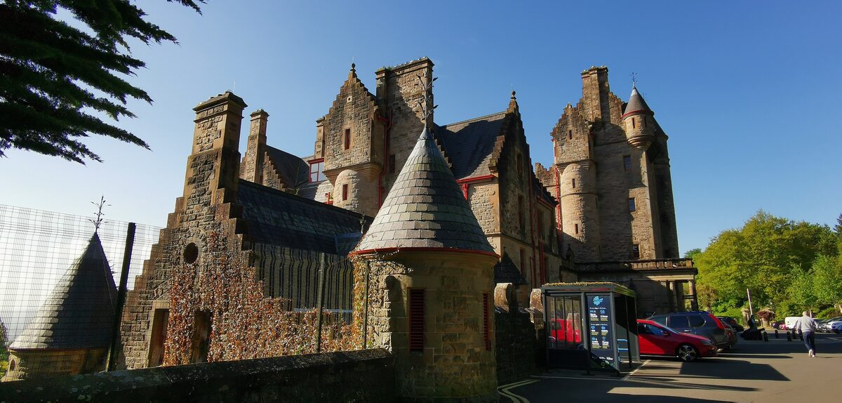Belfast Castle, a Scottish baronial mansion of sandstone with turrets and a tower, on the slopes of Cave Hill