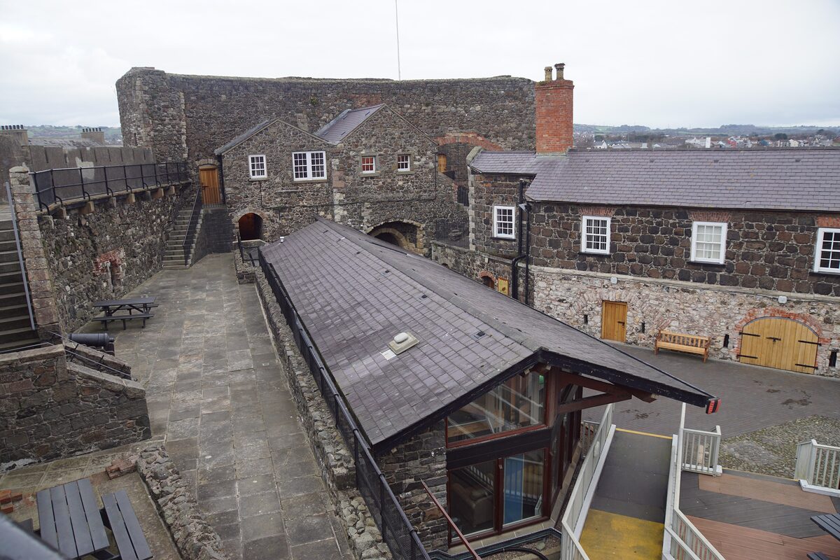 The courtyard and stone walls of Carrickfergus Castle, with its gatehouse