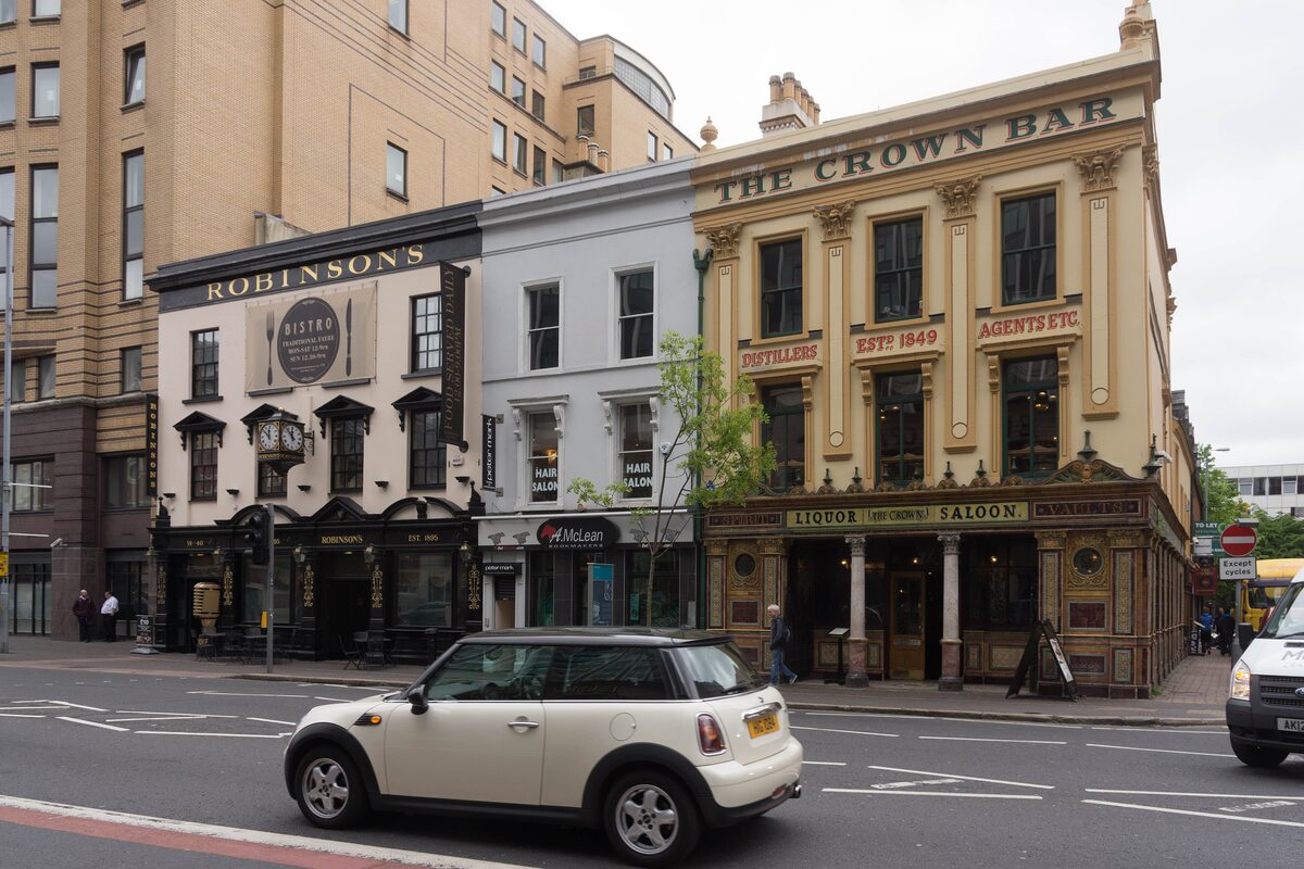 The ornate Victorian front of the Crown Liquor Saloon on Great Victoria Street, with its colored tiles and gold lettering