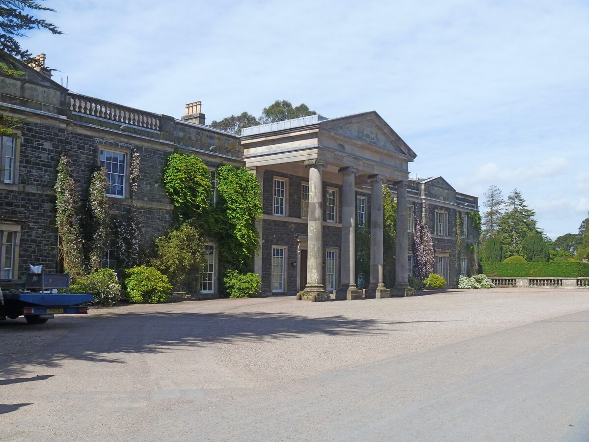 Mount Stewart House, a pale stone mansion with a columned porch covered in climbing plants