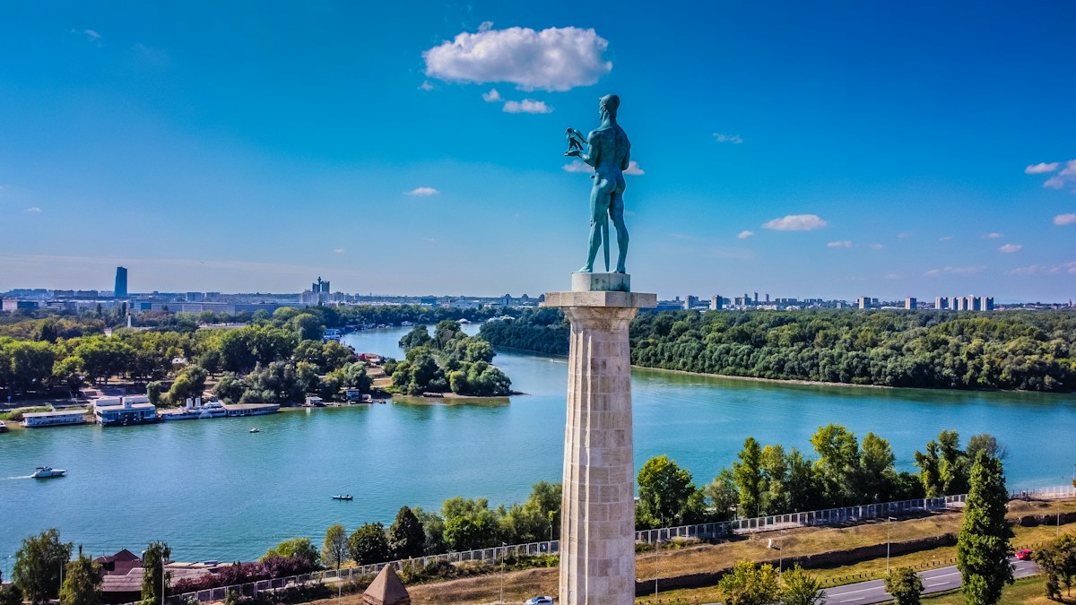 The Victor monument on its stone column at Kalemegdan, with the Sava meeting the Danube behind it
