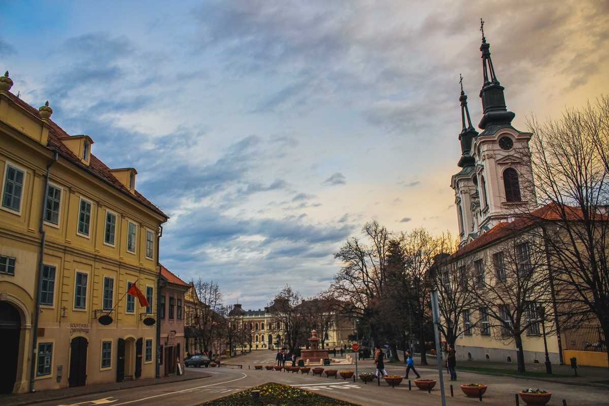 The main square of Sremski Karlovci with the twin baroque towers of St. Nicholas Cathedral and the Four Lions fountain