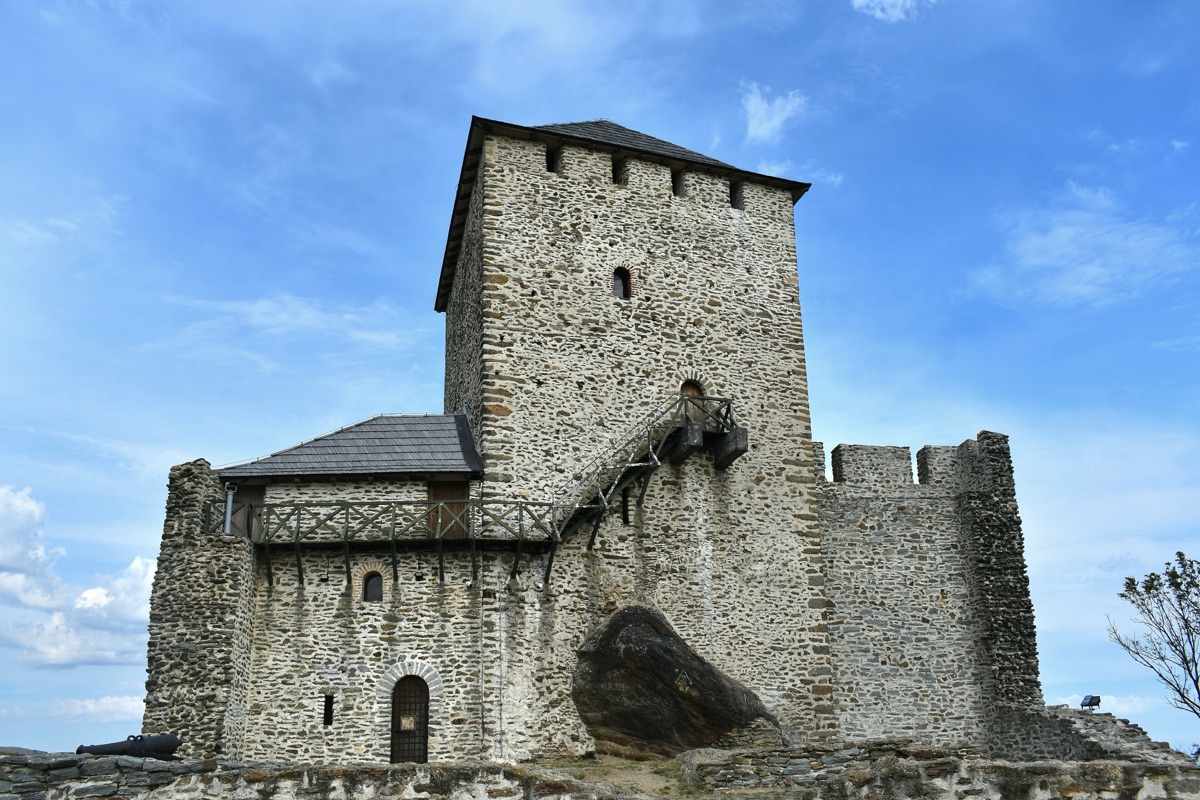The medieval stone keep of Vršac Tower under a blue sky
