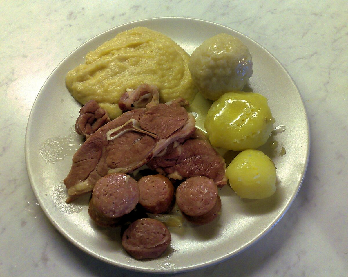 A plate of raspeballer: a grey potato dumpling with salted lamb, sausage, boiled potatoes and mashed swede