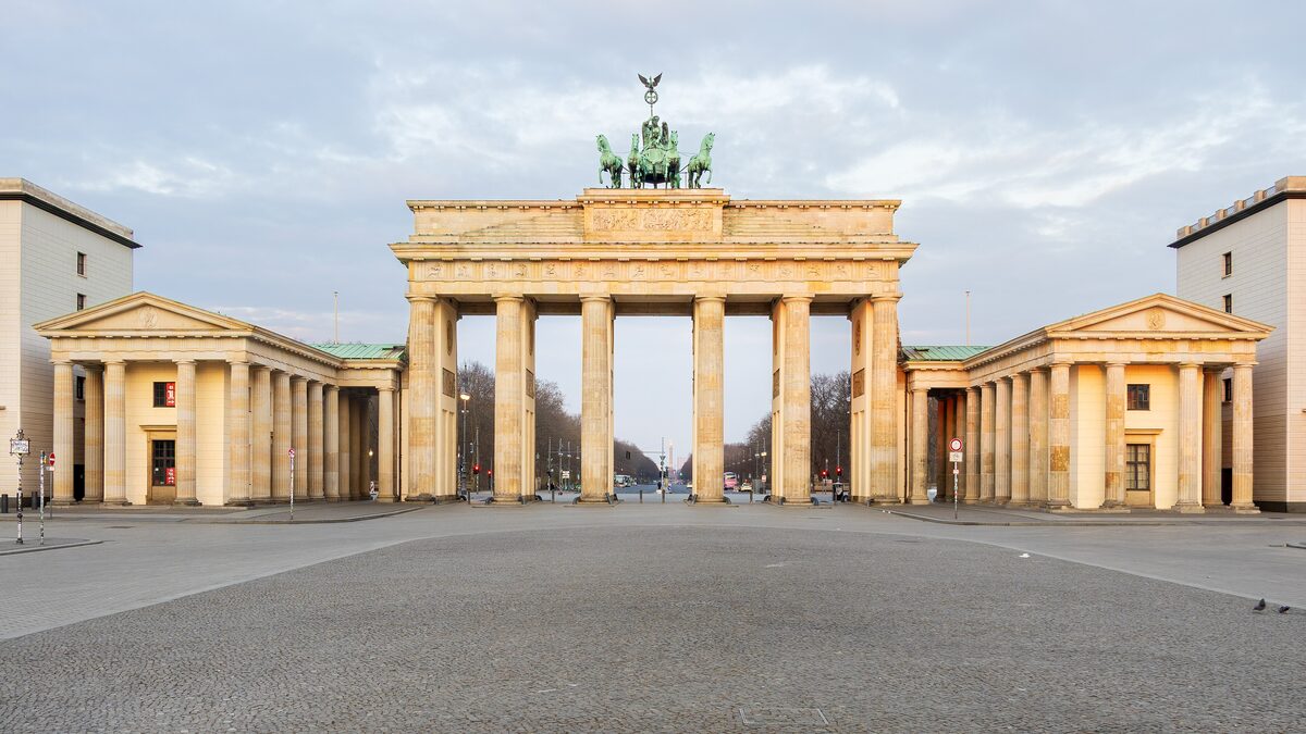 The Brandenburg Gate seen from Pariser Platz in warm morning light, with the quadriga on top
