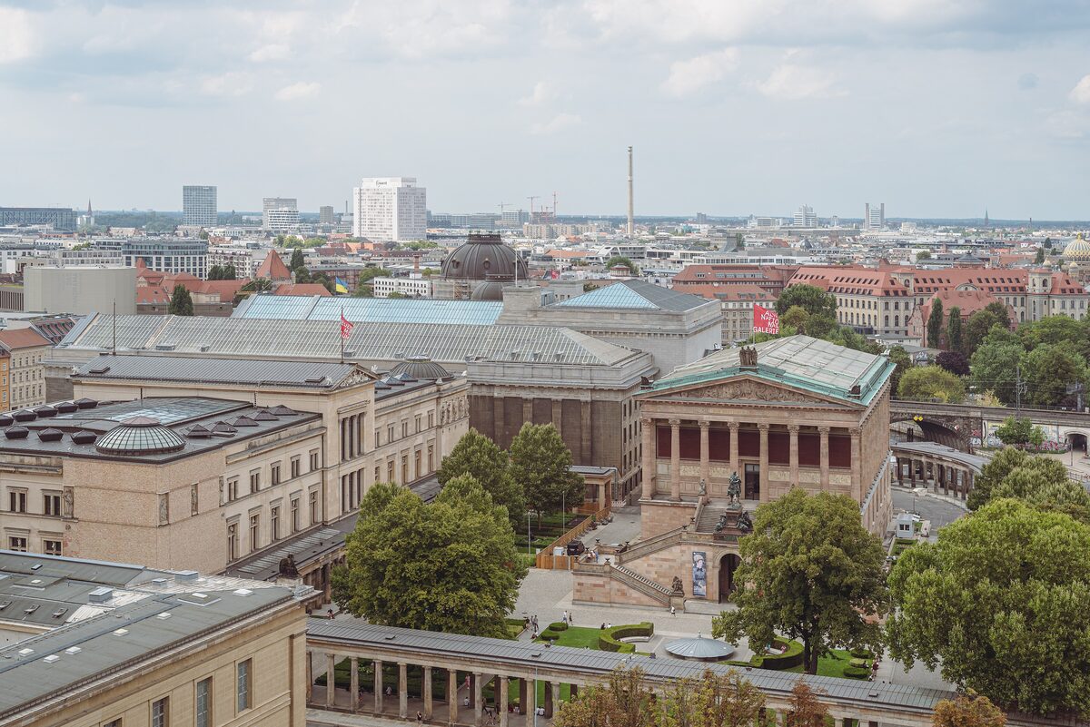 View from the Berlin Cathedral dome over Museum Island, with the Neues Museum and the columned Alte Nationalgalerie among trees