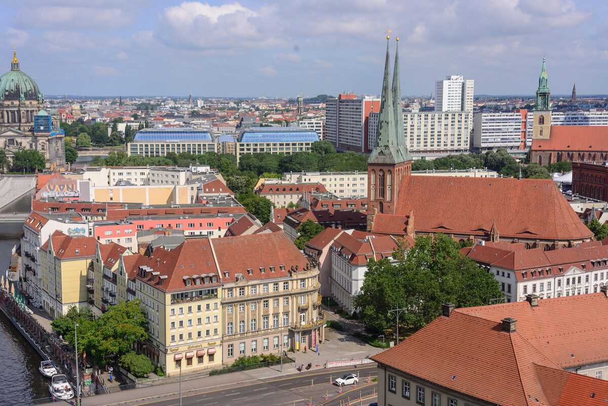Rooftop view over the Nikolaiviertel with the twin spires of the Nikolai Church and the Spree embankment on the left