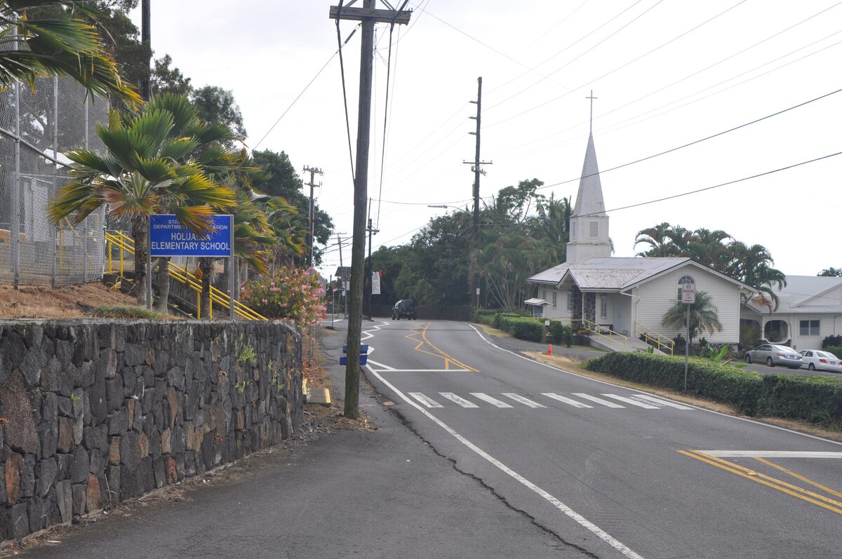 Hōlualoa's main road with a white church spire beyond