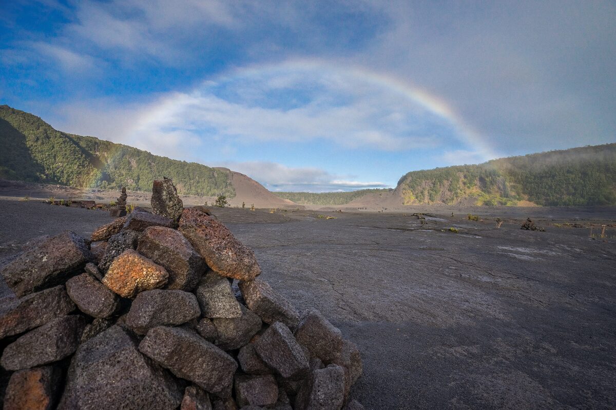 A rainbow over the black floor of Kīlauea Iki