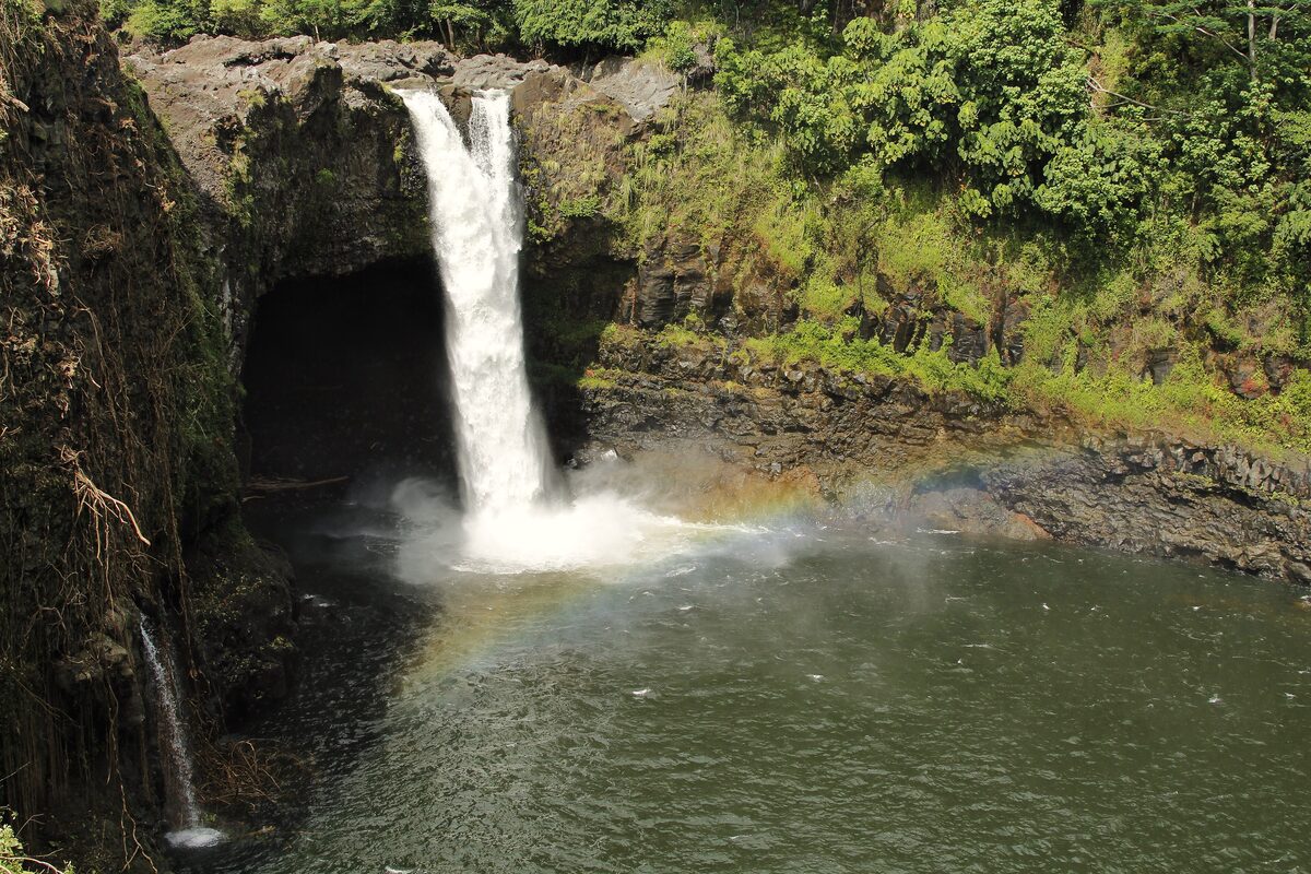 Rainbow Falls pouring into a pool with a small rainbow
