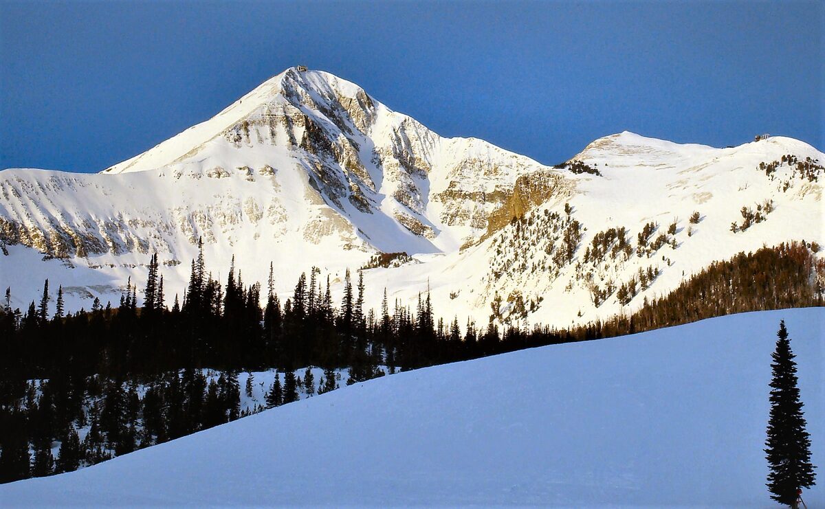 Lone Mountain in winter, the peak whose north-facing slope Moonlight Basin and Big Sky once shared, white above dark spruce