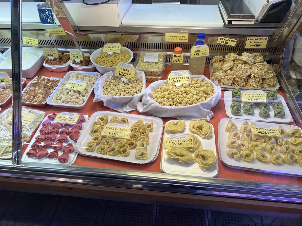 Fresh filled pasta and tagliatelle in trays behind a glass counter