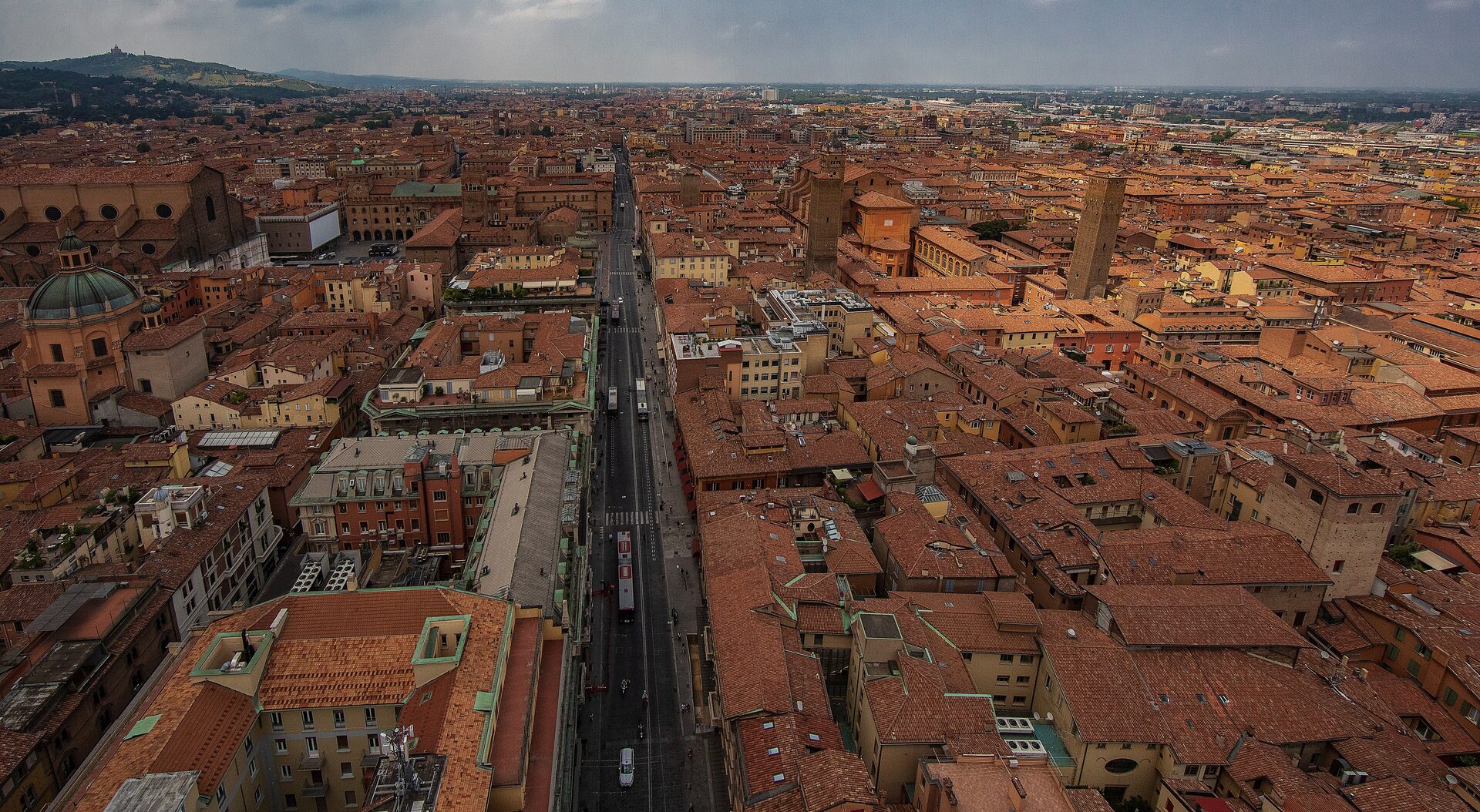 Red rooftops of Bologna seen from the Torre degli Asinelli, with San Petronio on the left and the San Luca hill far behind