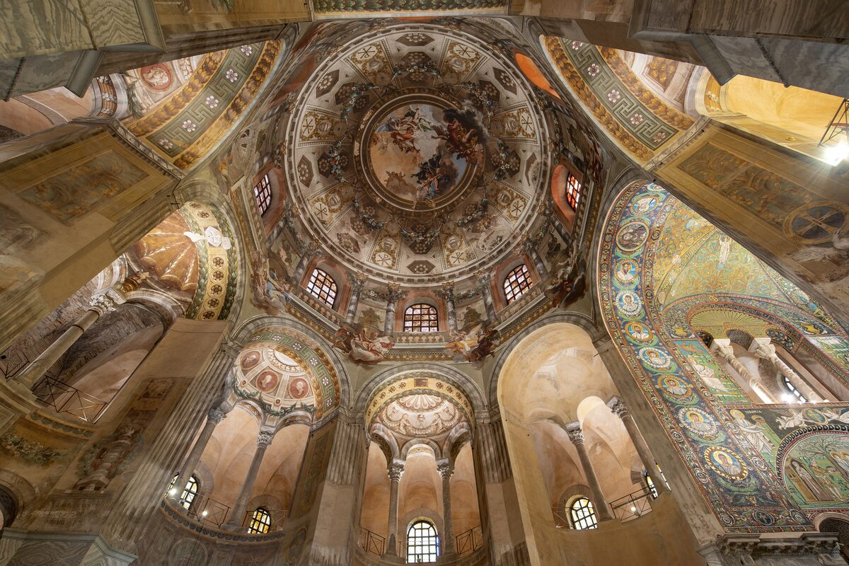 The frescoed dome and mosaic-lined arches inside San Vitale in Ravenna