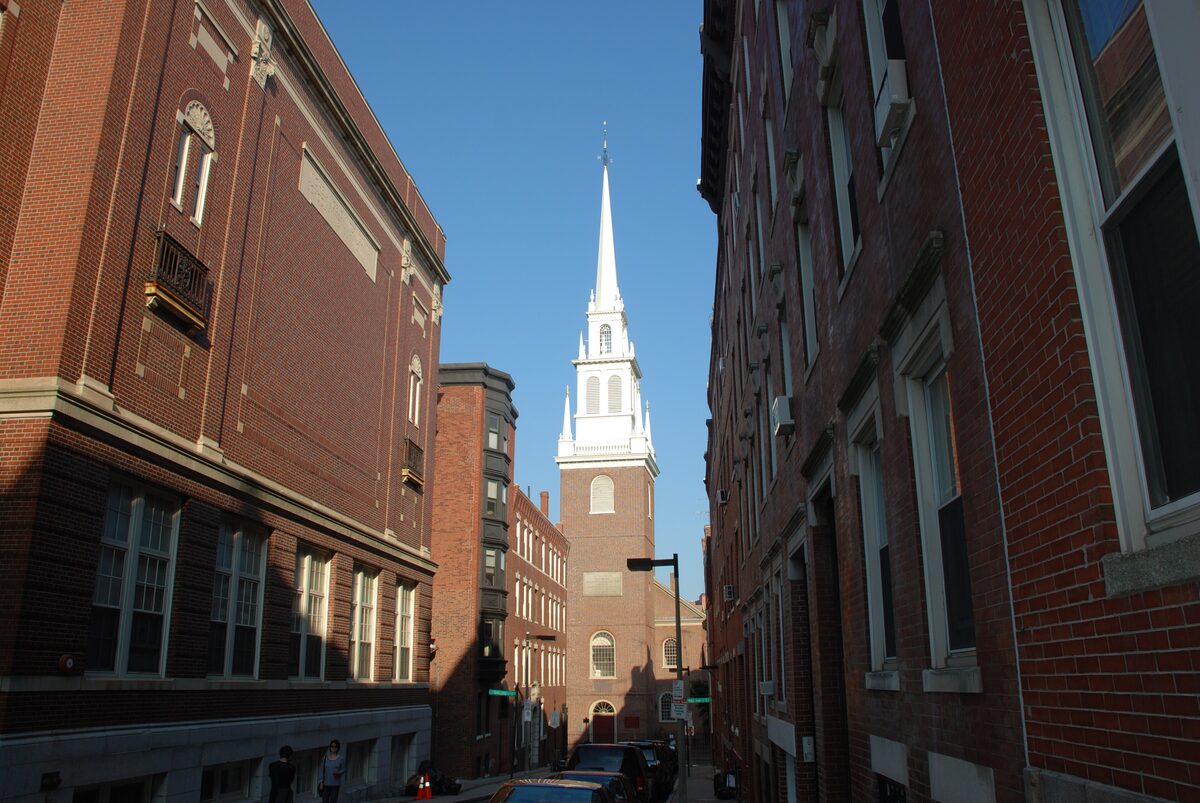 The white steeple of Old North Church seen down a North End street