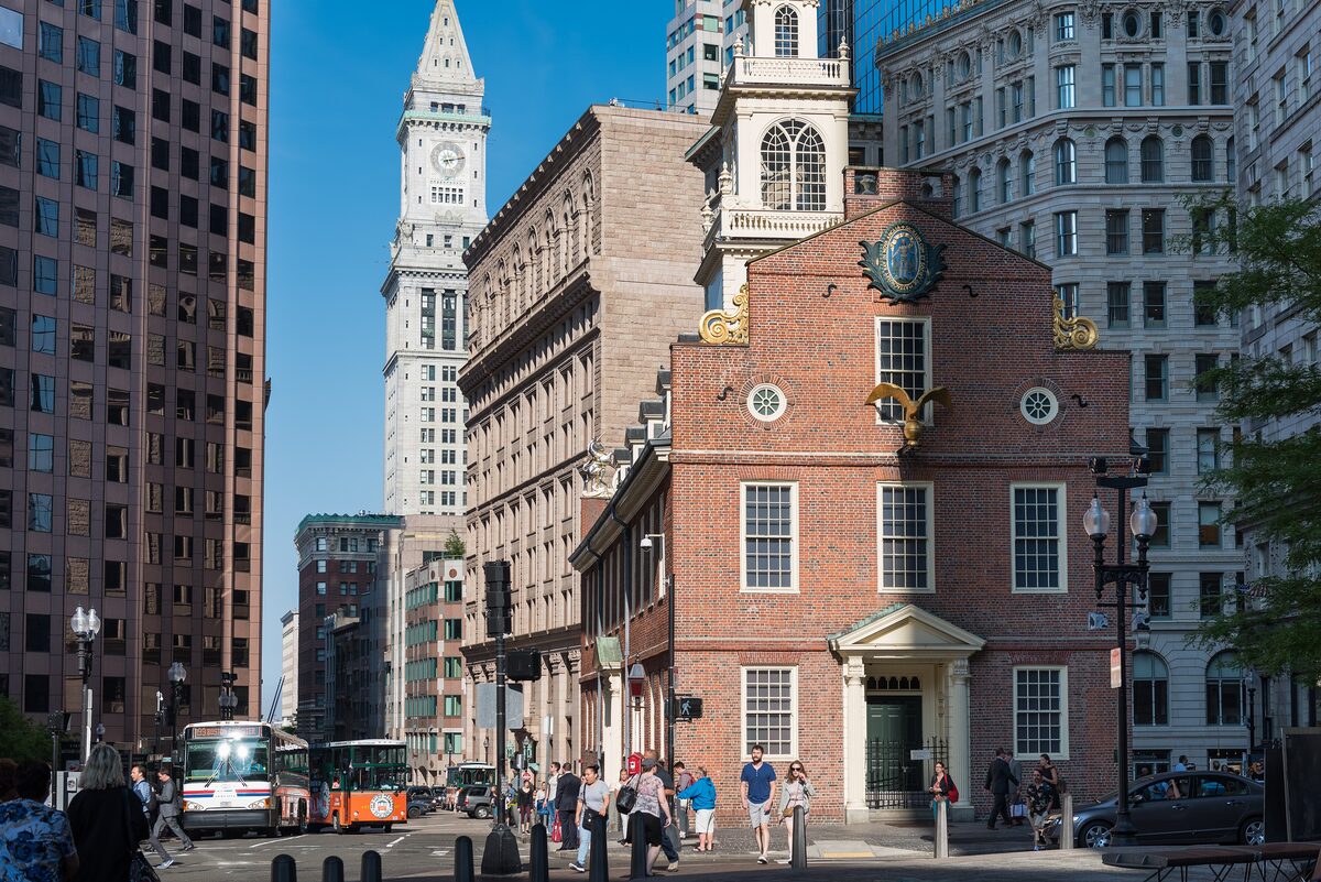 The brick Old State House with its tiered tower among downtown skyscrapers
