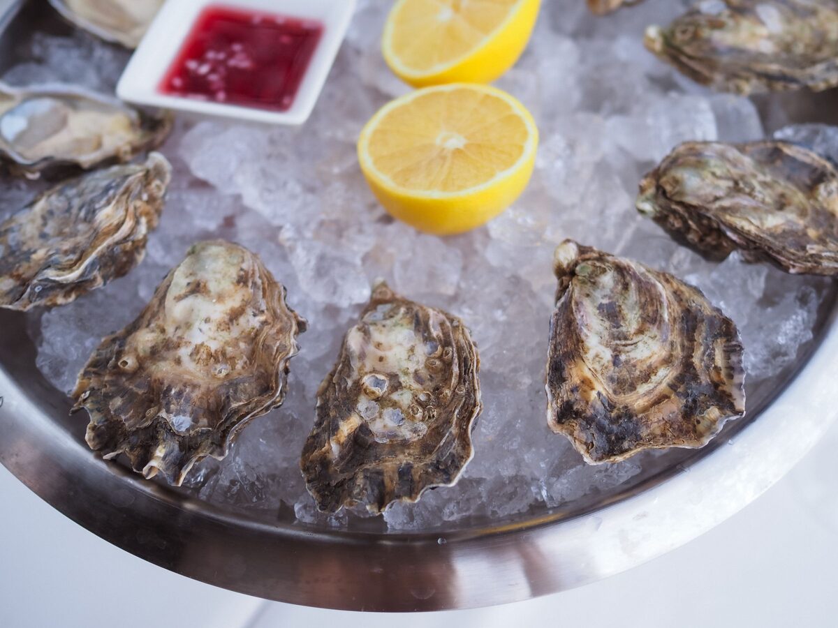 Raw oysters on crushed ice with lemon and cocktail sauce