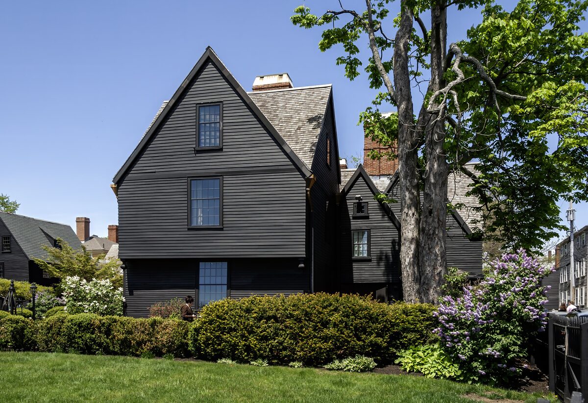 The dark-timbered gabled House of the Seven Gables behind a green lawn