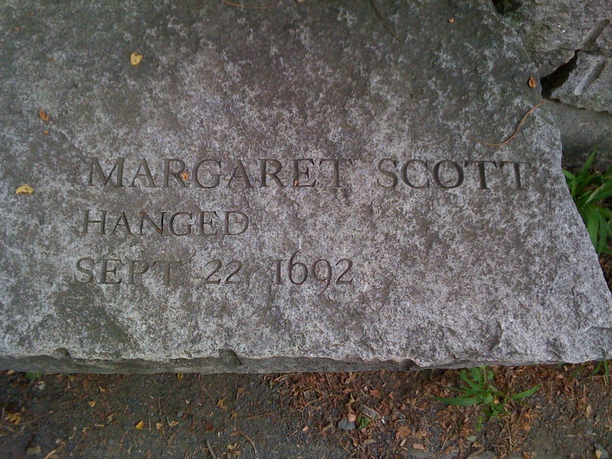 Granite memorial bench cut with the name of Margaret Scott, hanged 1692