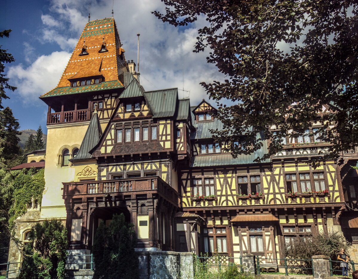 Pelișor, a half-timbered villa with steep green roofs and a tall tower with an orange tiled roof