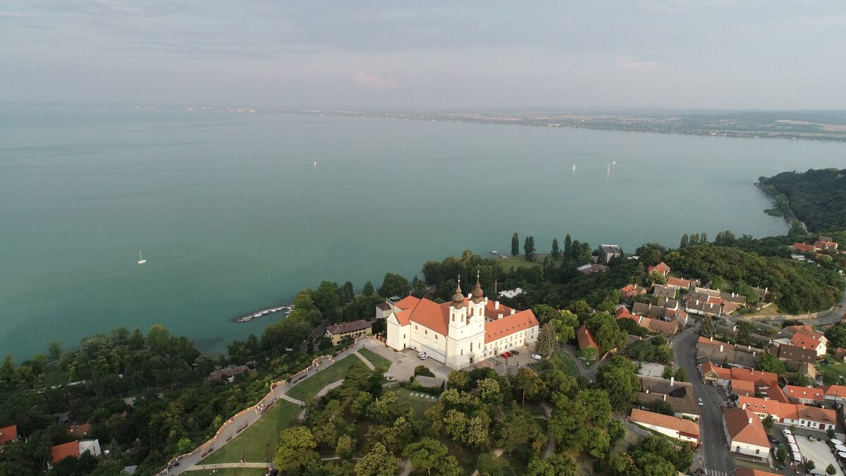 Aerial view of Tihany Abbey's twin-towered church above the village and Lake Balaton