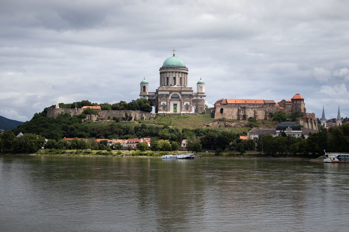 Esztergom Basilica and the castle on their hill above the Danube, under a cloudy sky