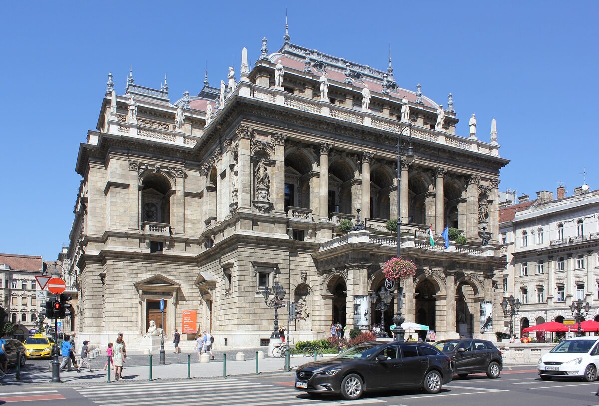 The neo-Renaissance Hungarian State Opera on Andrássy Avenue under a blue summer sky