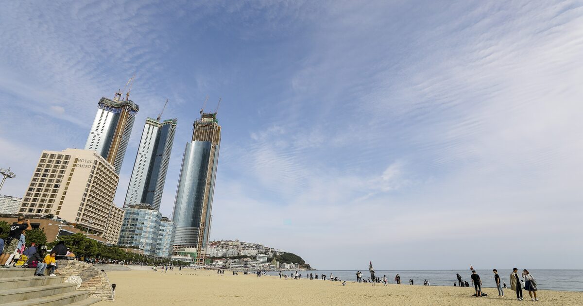 Sandy Haeundae Beach on a clear day, with the glass towers of Marine City rising behind the sand