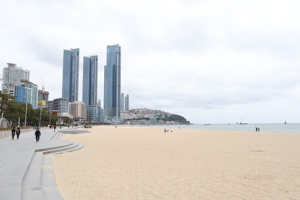 Haeundae Beach with its wide sand and the glass towers of Marine City at the far end
